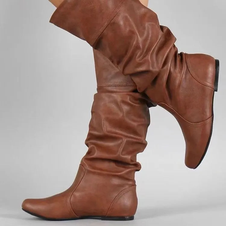 Women's flat slip-on long boots in black with round toe and high cylinder shaft, on a rubber sole.