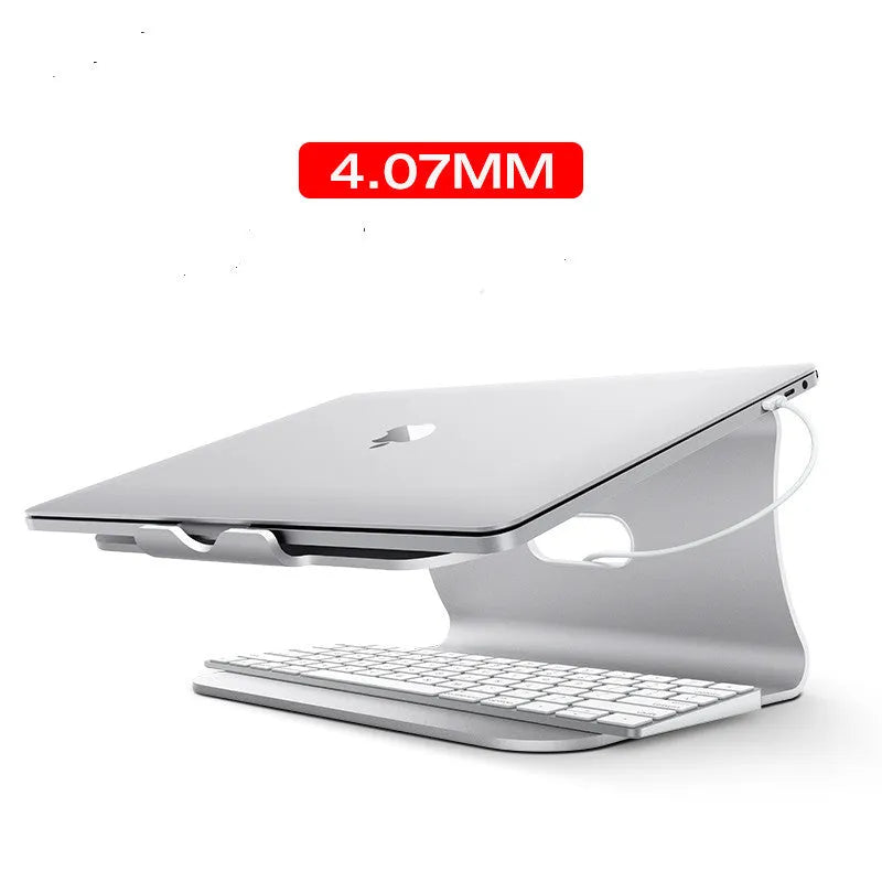 Silver aluminium laptop cooling stand with rotary base, 4.07mm thick, on a wooden desk.