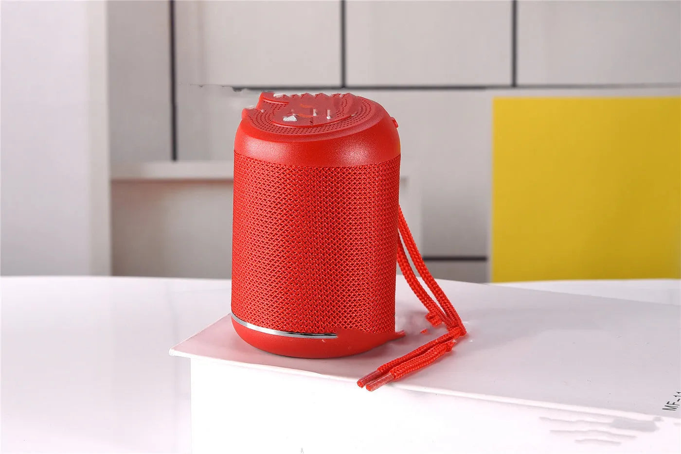 Portable outdoor Bluetooth subwoofer speaker in multiple colour options showing button controls.