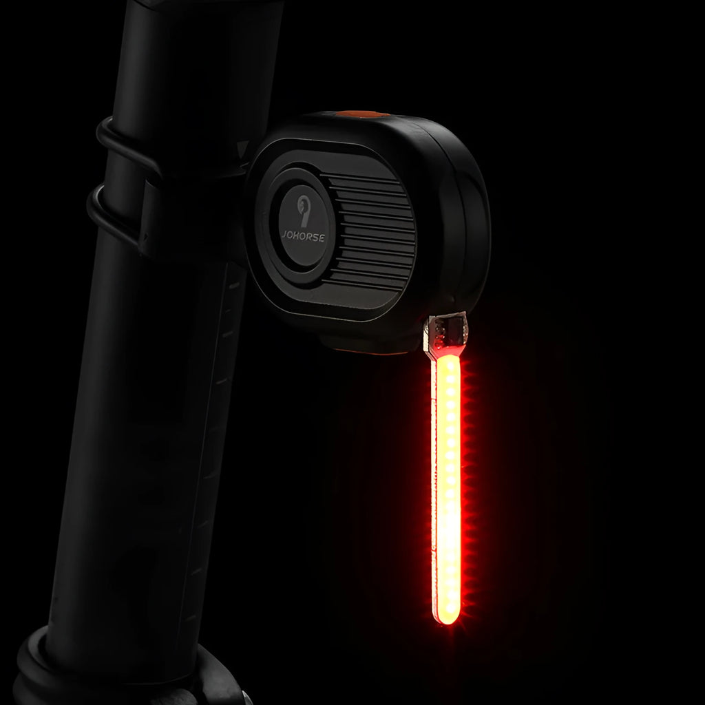 Bicycle rear safety light with cascading waterfall LED effect in blue, mounted on a bike seat post.