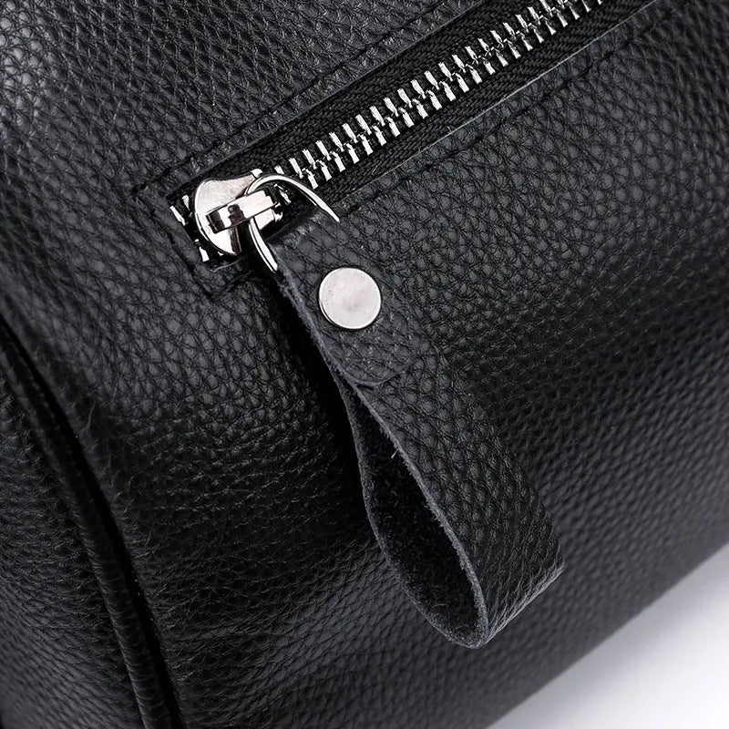 Black genuine leather one-shoulder crossbody bag showing its large capacity and strap.