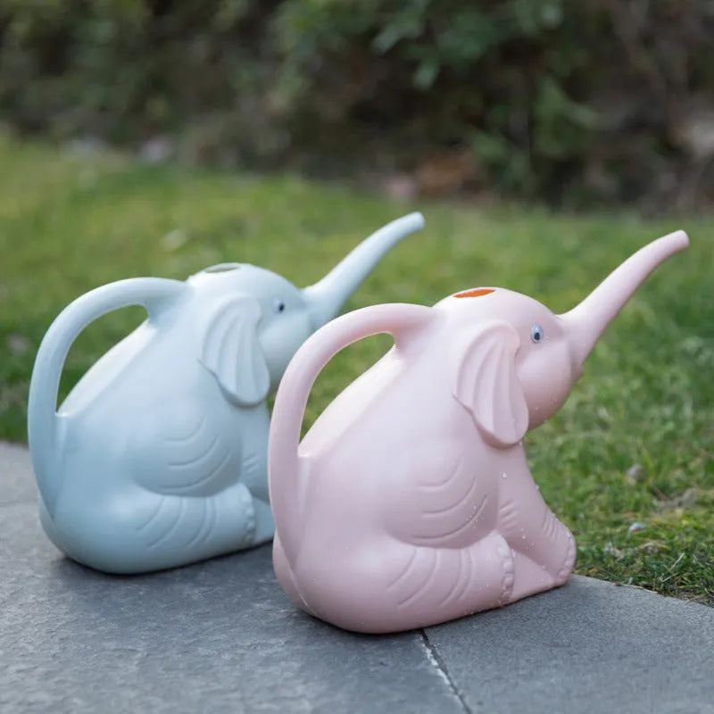 Pink elephant-shaped children's watering can with a long nozzle for gardening.