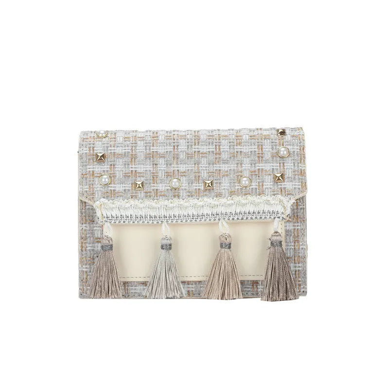 Ethnic-style horizontal square PU bag in beige with polyester lining, medium-hard structure, and flat lay on surface