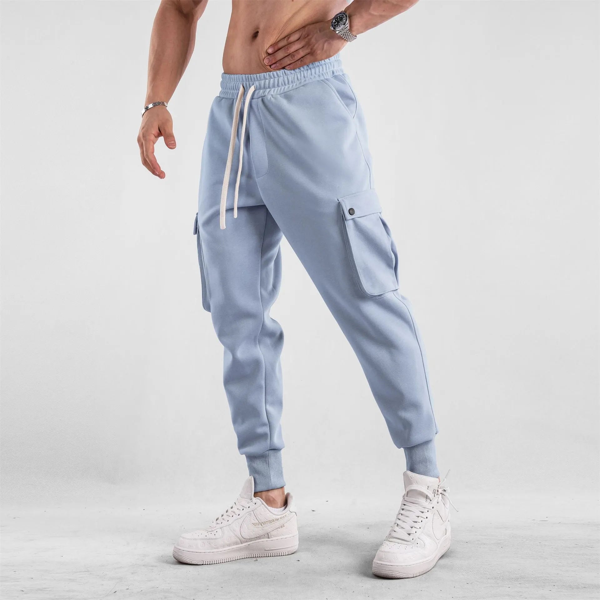 Men's loose-fit cotton sports trousers with ankle ties and multiple pockets in solid colour