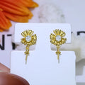 A pair of Baroque-style floral earring frames made of sterling silver, featuring a small integrated ring holder, presented without pearls.