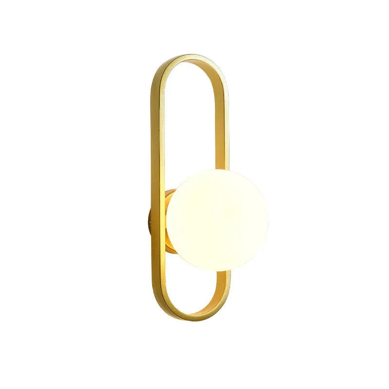 Minimalist wall-mounted lamp with glass shade and iron body in black or gold finish, showing 12W tri-colour LED light.
