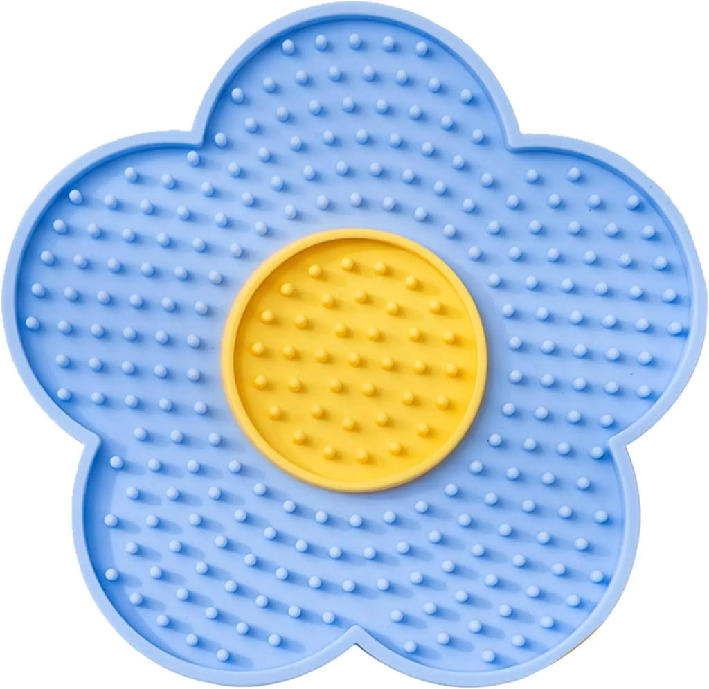 Flower-shaped silicone lick mat for dogs and cats with suction cups on a blue background.