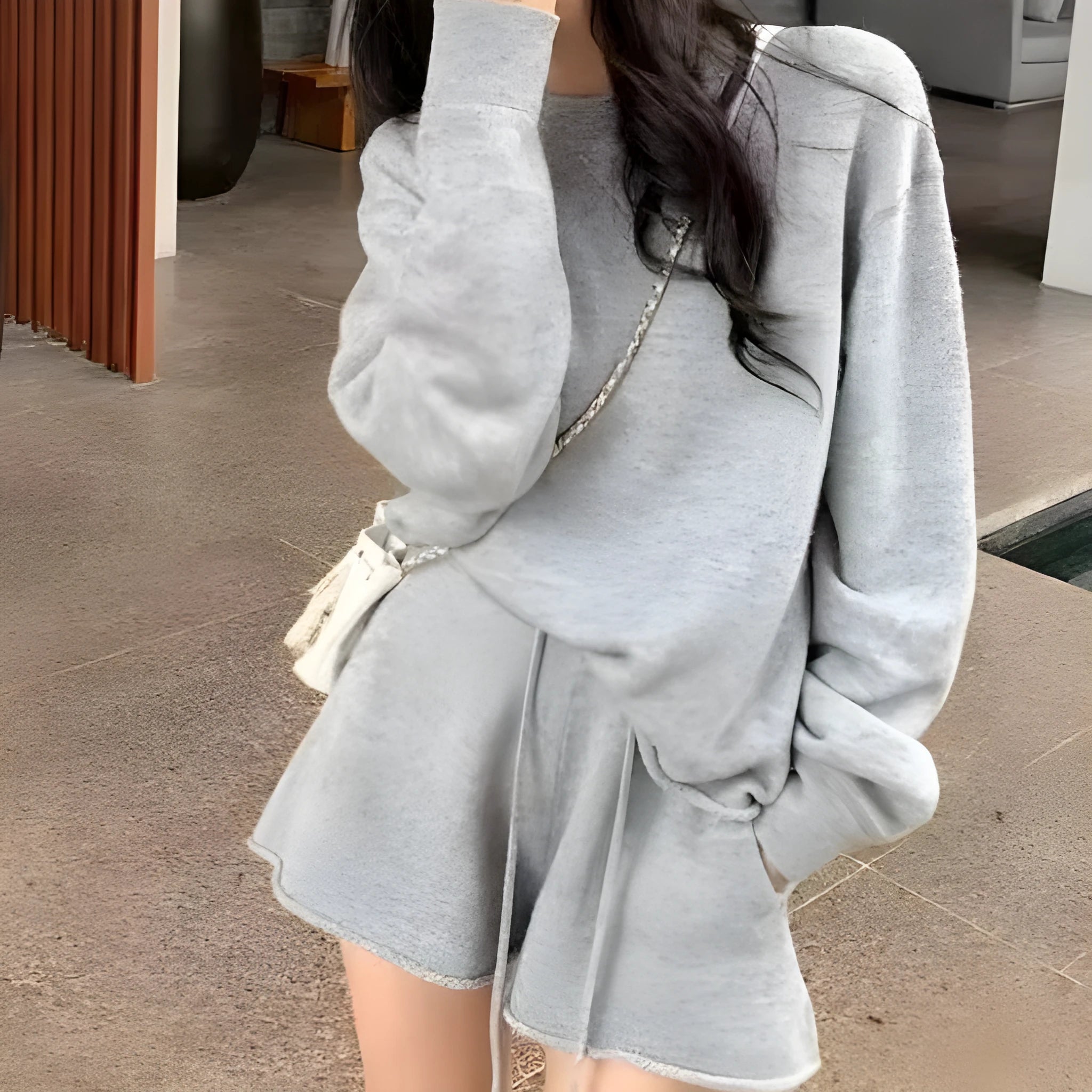 Women's loose grey acrylic knit sweater and wide-leg shorts set laid flat.