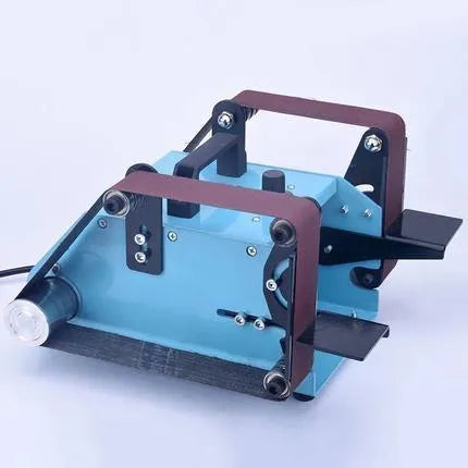 Blue desktop dual-axis belt sander with variable speed switch on a workbench.