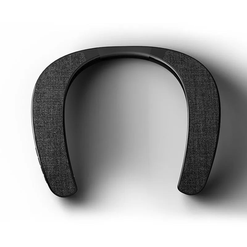 Black neck-mounted stereo wireless Bluetooth speaker with USB charging cable on neutral background