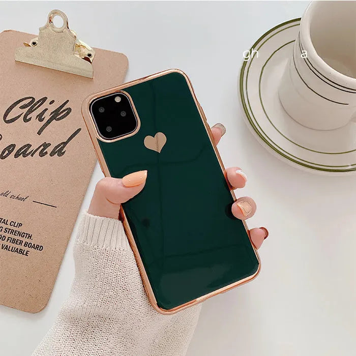 Solid colour TPU back cover case for iPhone on a table, shown in blue, claret, pink, and green.