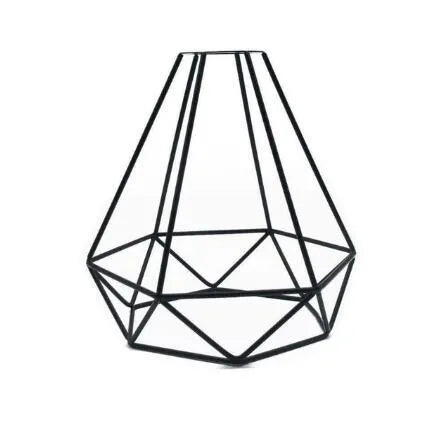 Minimalist hollow iron table lamp with warm white light on a wooden desk