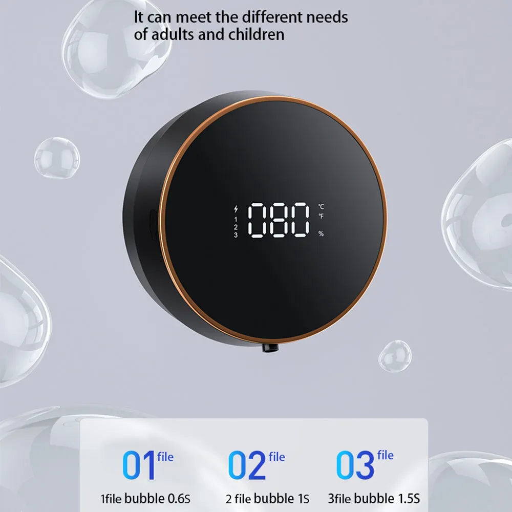 Black automatic sensor foam soap dispenser mounted on a wall with a USB cable connected.