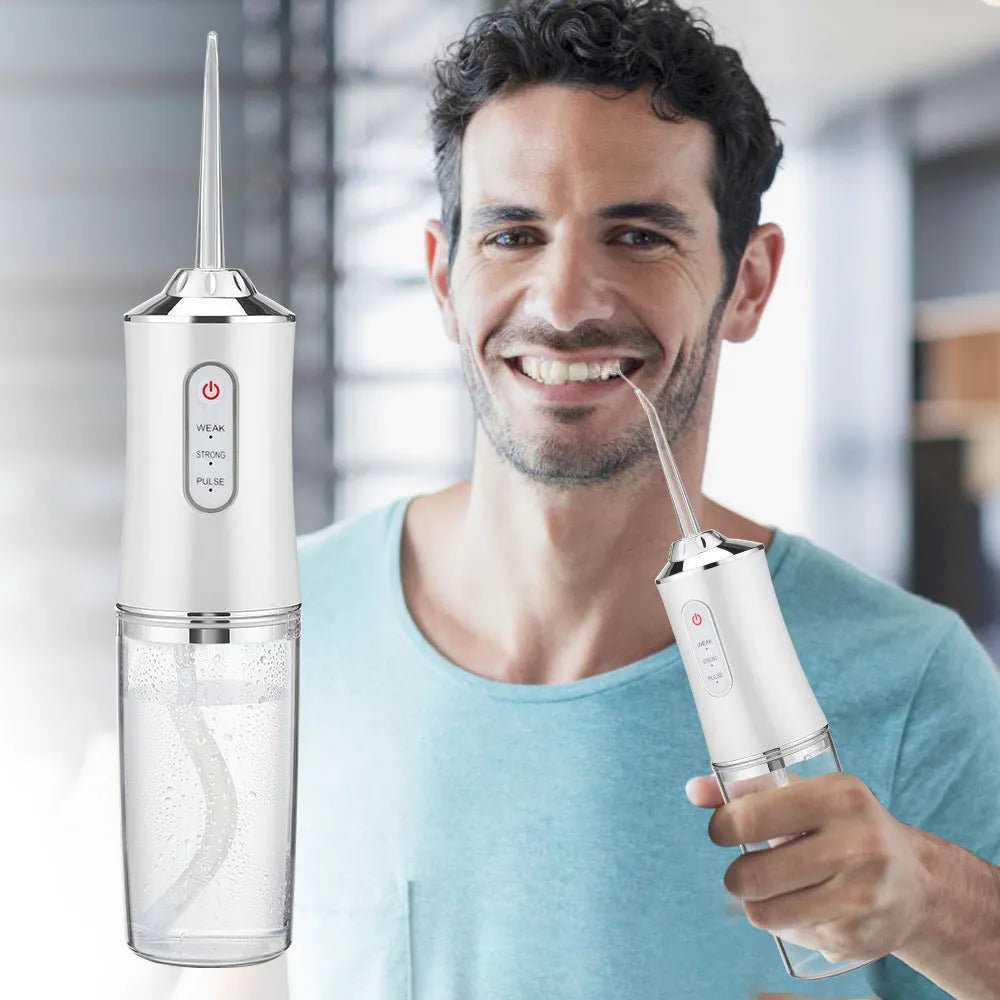 Handheld electric water pick in white, pink or light green with three speed settings, under 300mL tank, USB cable and four nozzles