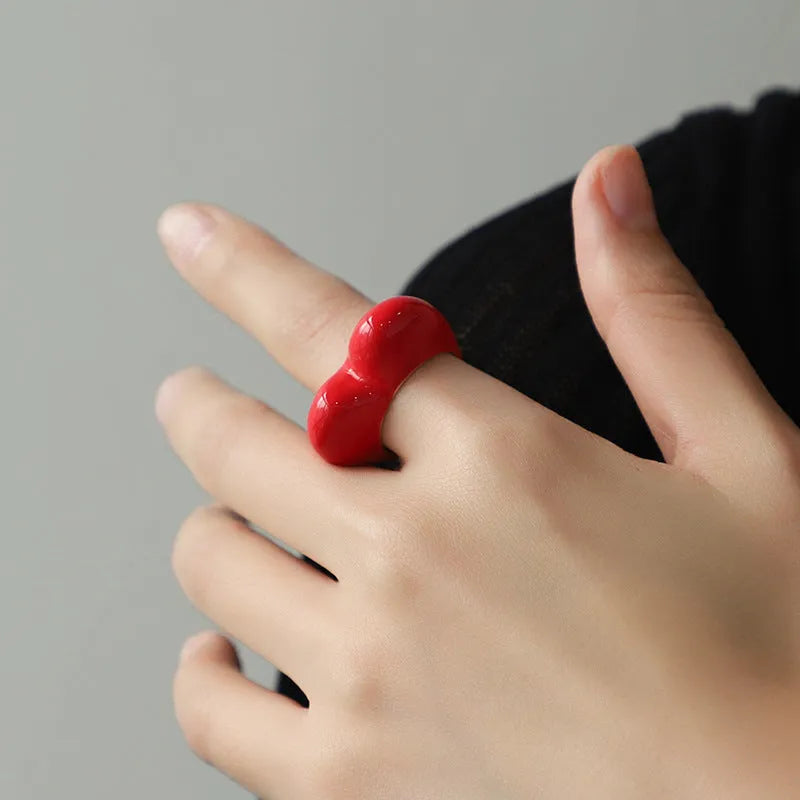 Close-up of a colourful three-dimensional enamel heart ring on a zinc alloy band.