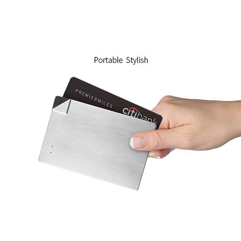Silver ultra-thin 4mm graphene power bank next to a mobile phone showing its slim profile.