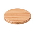 Natural bamboo wireless charger pad on desk with a smartphone placed on it