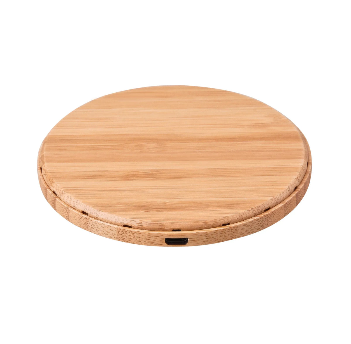 Natural bamboo wireless charger pad on desk with a smartphone placed on it