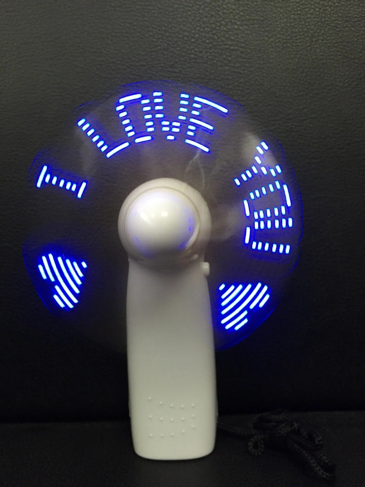 White handheld mini fan with flashing blue and red LED 'I Love You' pattern on display.