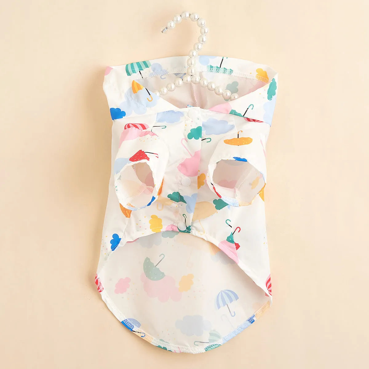 Colourful cartoon umbrella pattern dog raincoat sized L on a golden retriever.