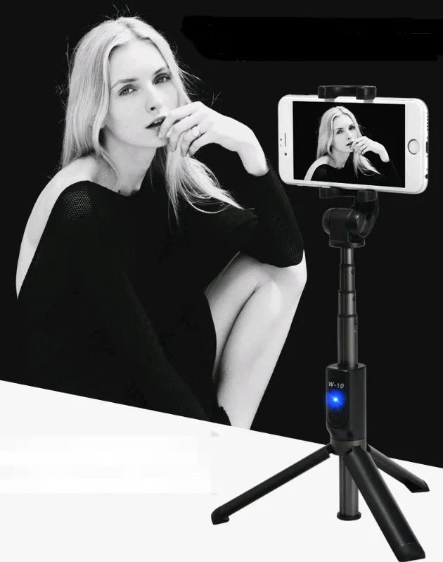 Black Bluetooth selfie stick with extended tripod legs holding a smartphone