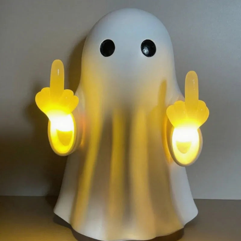 White cute ghost statue plastic night lamp for Halloween decoration on a dark surface.
