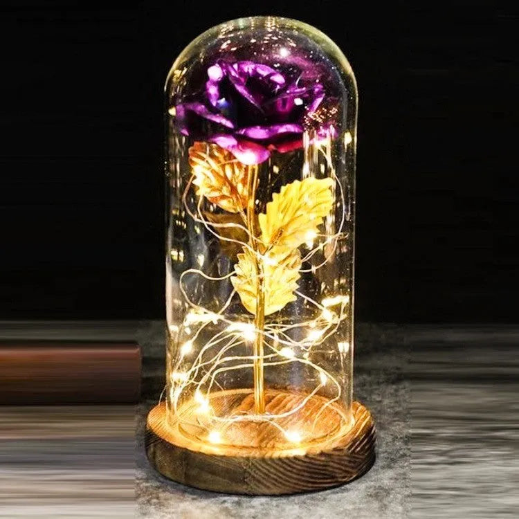 LED rose bouquet with glass lampshade showing warm white lights on simulation silk flowers.