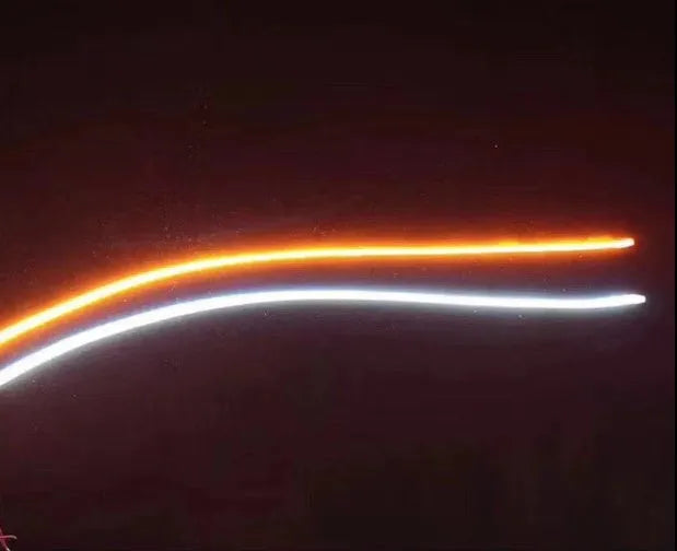 60cm ultra-thin car LED tear light guide strip in white yellow two-colour mode on a dark background