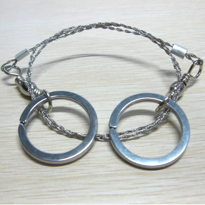 Stainless steel survival wire saw with ring attachments showing 55cm cutting length