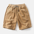Men's khaki retro cargo shorts with straight leg fit on a white background
