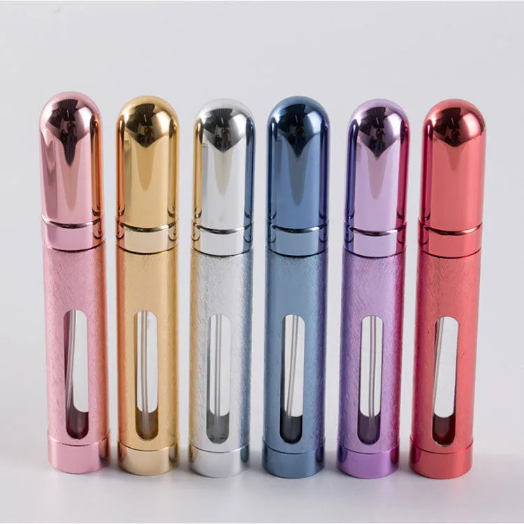 Refillable aluminium travel perfume atomiser with glass liner in blue, gold, pink, red, silver, or violet.
