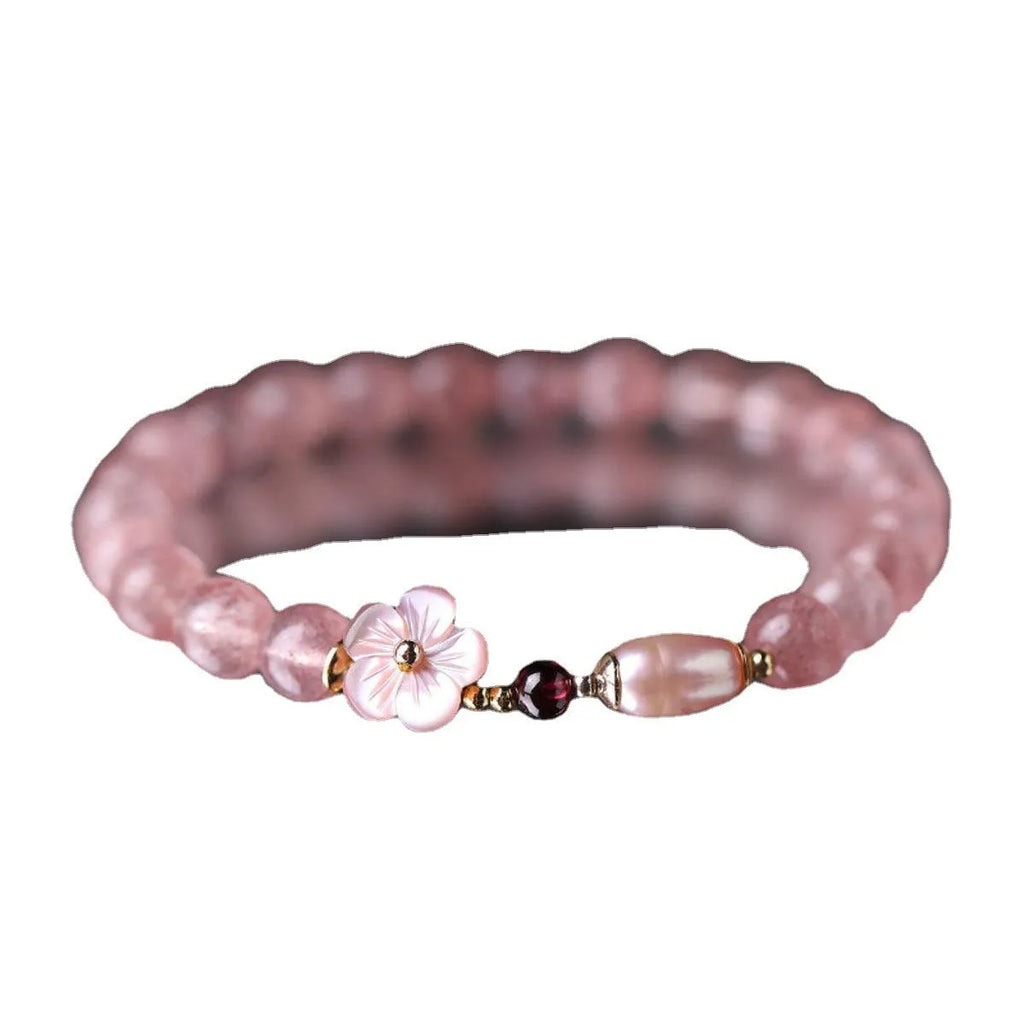 Light pink strawberry quartz crystal bracelet with peach blossom floral design and adjustable fastening