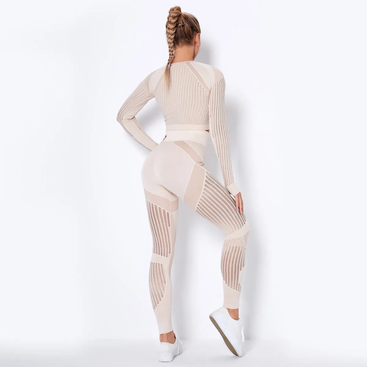 Women's long-sleeved seamless yoga wearsuit in a dark colour, shown in a yoga pose.