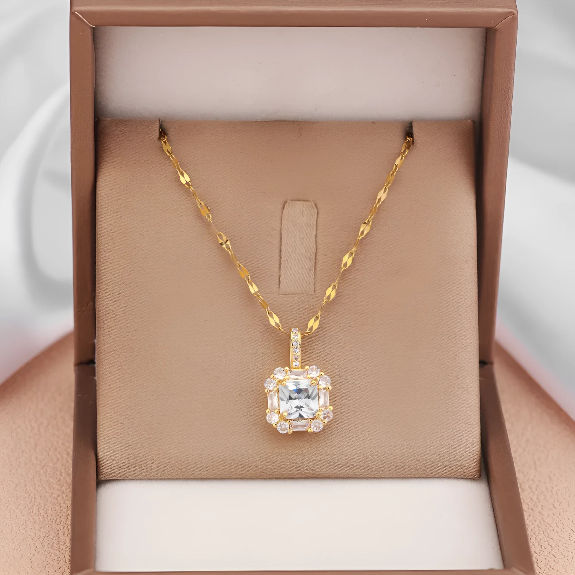 Gold geometric quadrilateral pendant with mixed gem inlays on titanium steel water wave chain necklace
