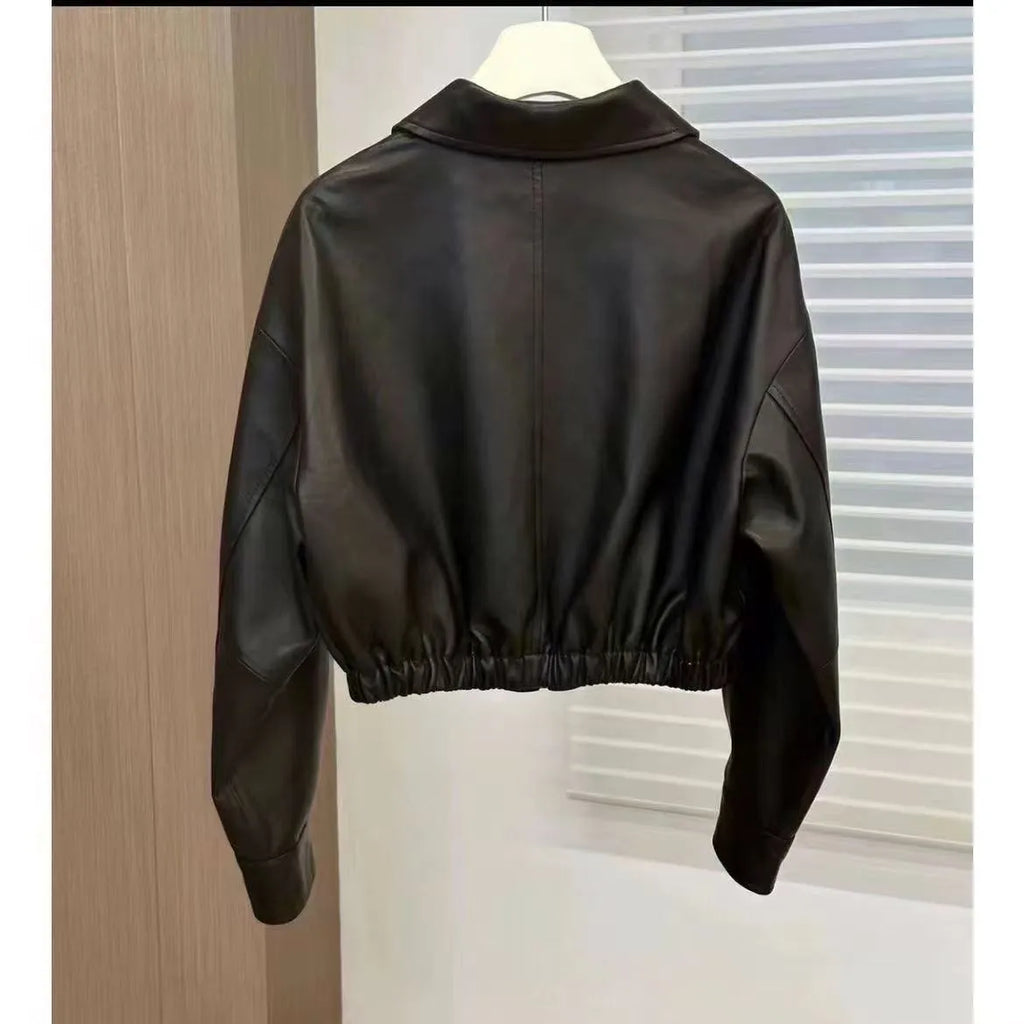 Women's black faux leather square-neck zip jacket with princess sleeves and washed finish on a model