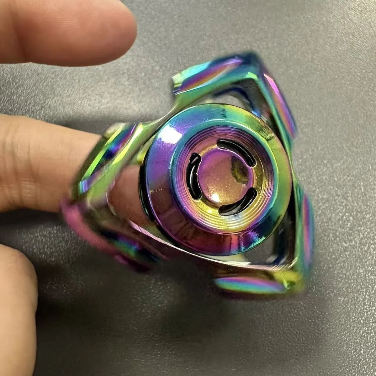 A silver and a colourful alloy metal fingertip decompression gyro spinner toy.