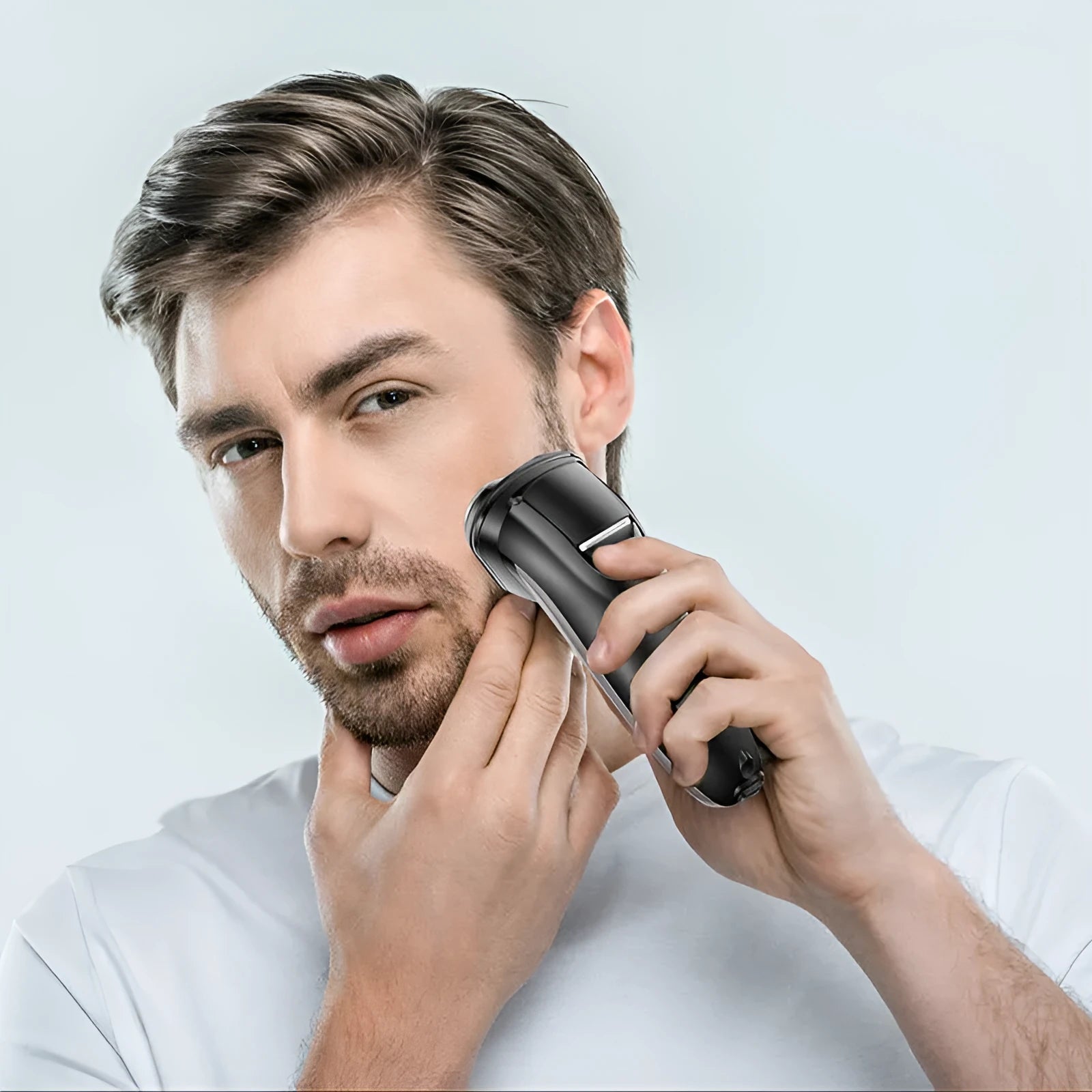Men's electric shaver kit with three floating heads, pop-up trimmer, USB cable, and accessories on grey background
