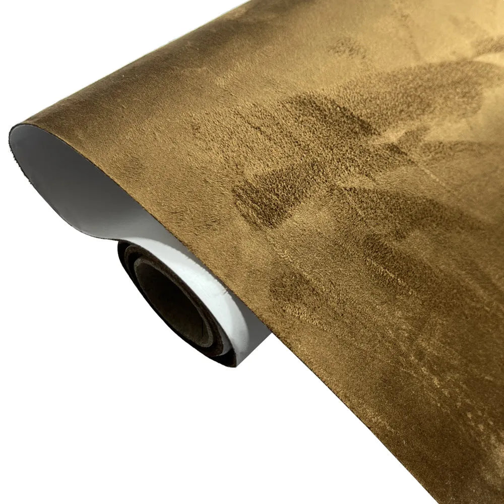 Roll of self-adhesive leather suede fabric in BMW brown colour next to a car dashboard.