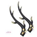 A pair of black resin dragon horn decorations for motorcycle helmets, showing curved shape and textured surface.