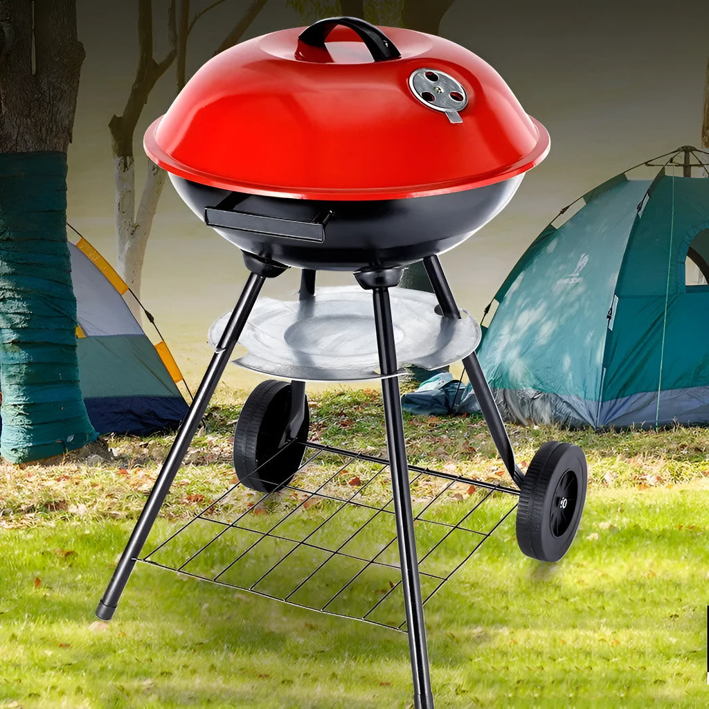Portable round iron barbecue grill with 14-inch cooking grate, shown on a patio.