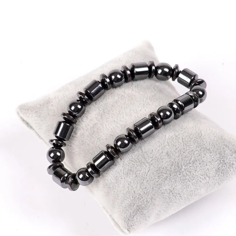 Black pentagram symbol magnetic bracelet with magnetite and hematite stones on a stretch band.