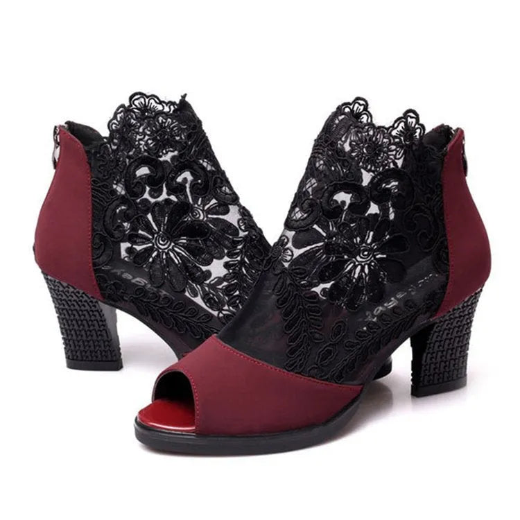 Women's black lace gladiator sandals with square heels and floral patterns, showing zip closure and peep toe design
