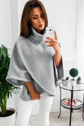 Women's long black batwing cardigan with three-button front and stitching detail, shown extended length.