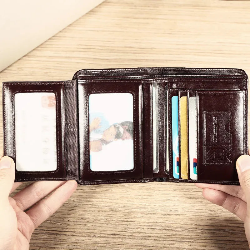Open view of a black men's leather bifold wallet showing card slots, photo window, and zipped coin pocket.