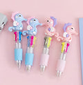 Four-colour press ballpoint pen with random cartoon design and silicone grip.
