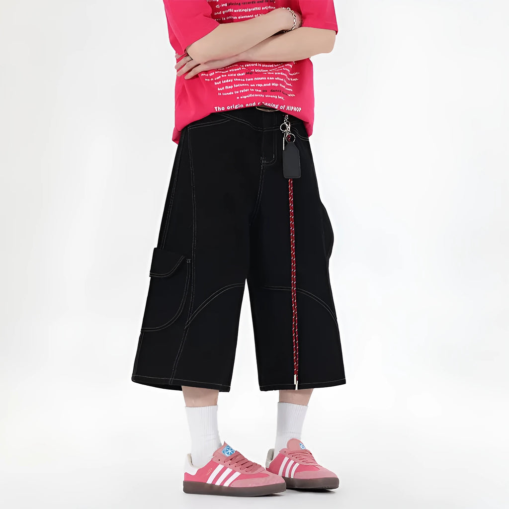 Men's red denim wide-leg cropped workwear shorts with multiple pockets on a mid waist