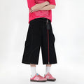 Men's red denim wide-leg cropped workwear shorts with multiple pockets on a mid waist