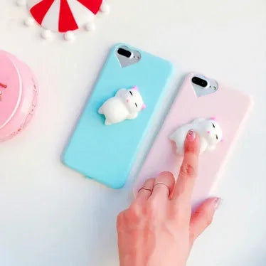 Soft pink silicone iPhone case with a raised 3D white cartoon cat design on the back.