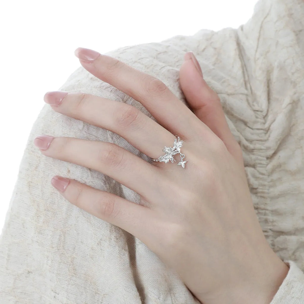 Silver butterfly ring with adjustable opening and electroplated gold finish options.