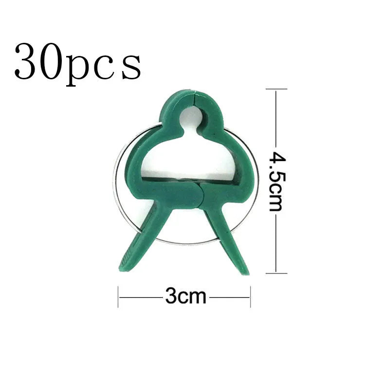 Green plastic and zinc plant fixing clips for supporting climbing tomato and cucumber vines.